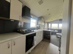 FlagShipSite-Caravan-Sleeps7-Fireplace-Garden